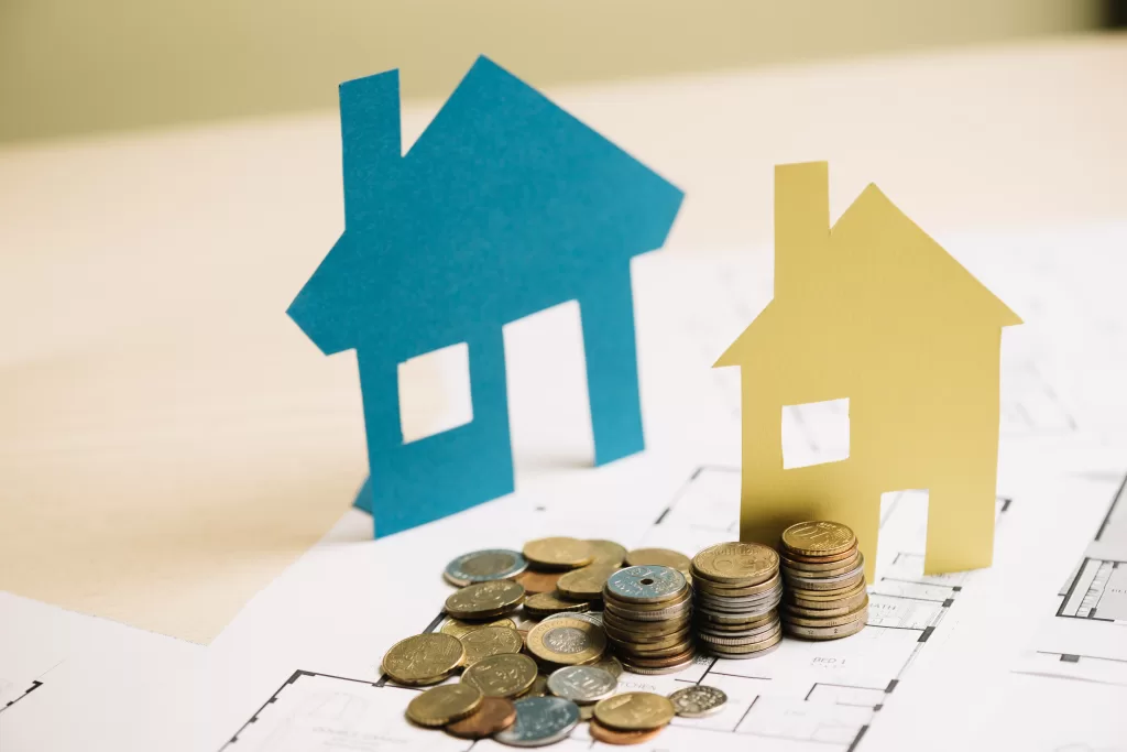 stack-of-coins-and-paper-houses.jpg