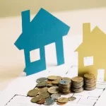 stack-of-coins-and-paper-houses.jpg