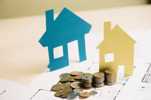stack-of-coins-and-paper-houses.jpg