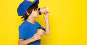 uma-vista-frontal-pequeno-correio-bonito-no-bone-azul-de-camiseta-azul-segurando-copos-de-cafe.jpg